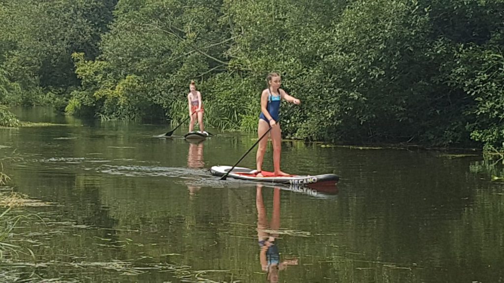 Paddle Boarding on the river at Two Jays Farm Campsite